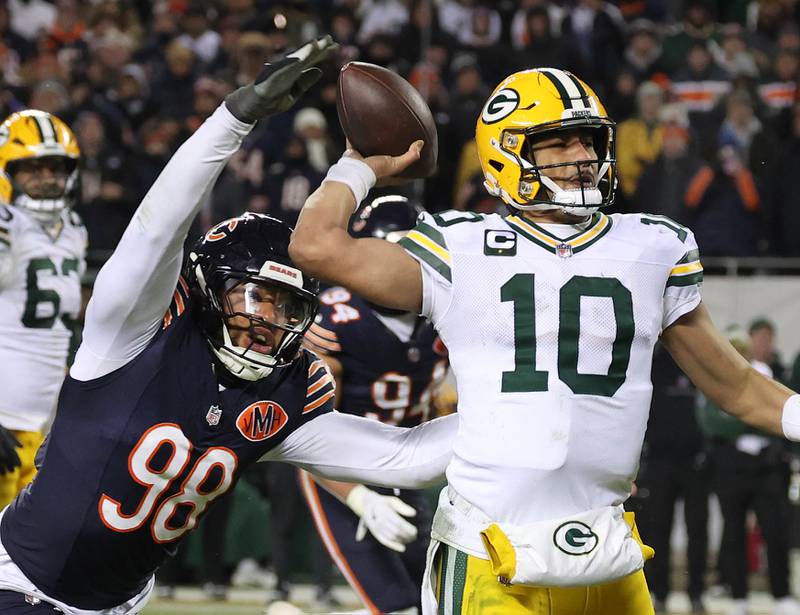 Chicago Bears defensive end Montez Sweat hits Green Bay Packers quarterback Jordan Love as he throws during the Packers last drive in the Bears NFL Wild Card game win Saturday, Jan. 10, 2026, at Soldier Field in Chicago.