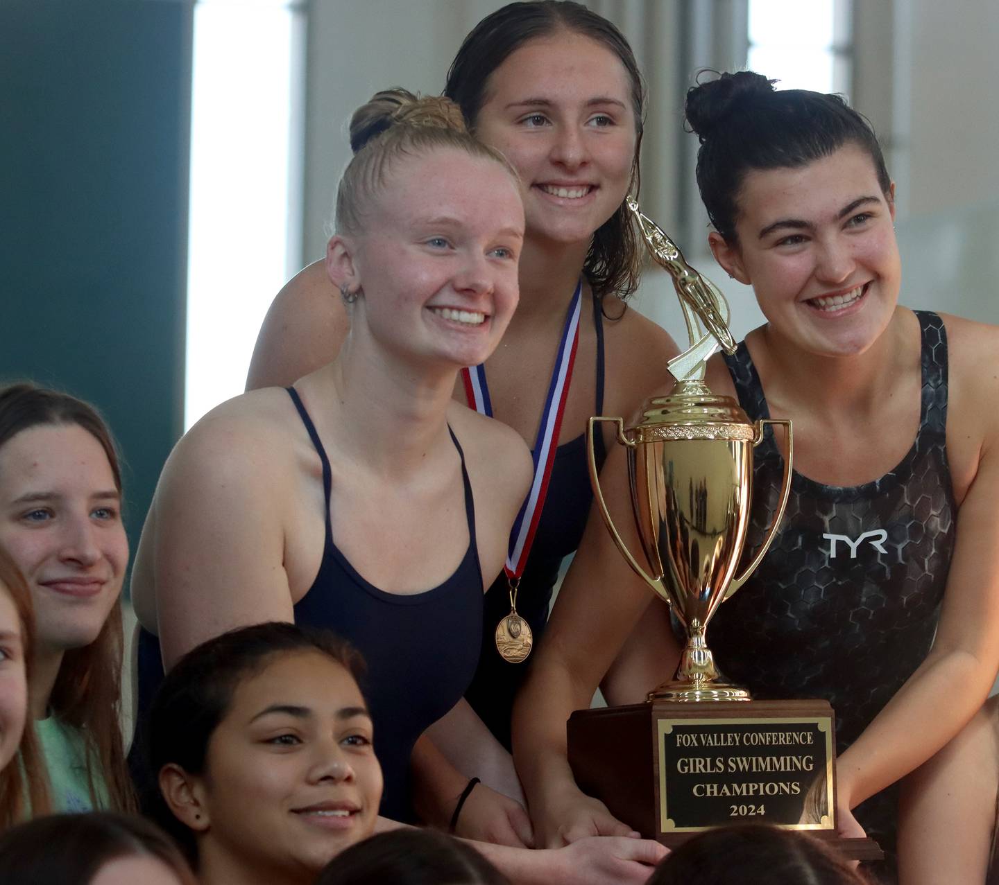 Swimmers from Dundee-Crown co-op pose with the trophy after the Fox Valley Conference Championship Meet at Woodstock North High School on Saturday, Nov. 2, 2024 in Woodstock .