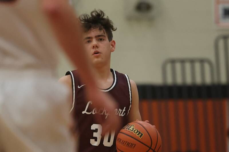 Lockport’s Evan Dziedkwiec works the ball up court against Minooka.