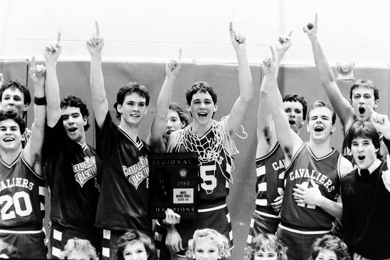 Members of the 1985-1986 L-P boys basketball team pose with the Regional plaque after defeating Ottawa during the Regional title game on Saturday, Feb. 28, 1986 at La Salle-Peru Township High School.
