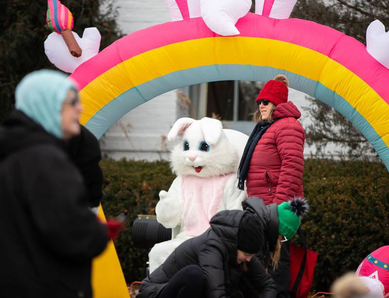 An attendee poses with the Easter Bunny during the Elmhurst Park District's Adult Easter Egg Hunt at Wilder Park on Saturday, March. 18, 2023.
