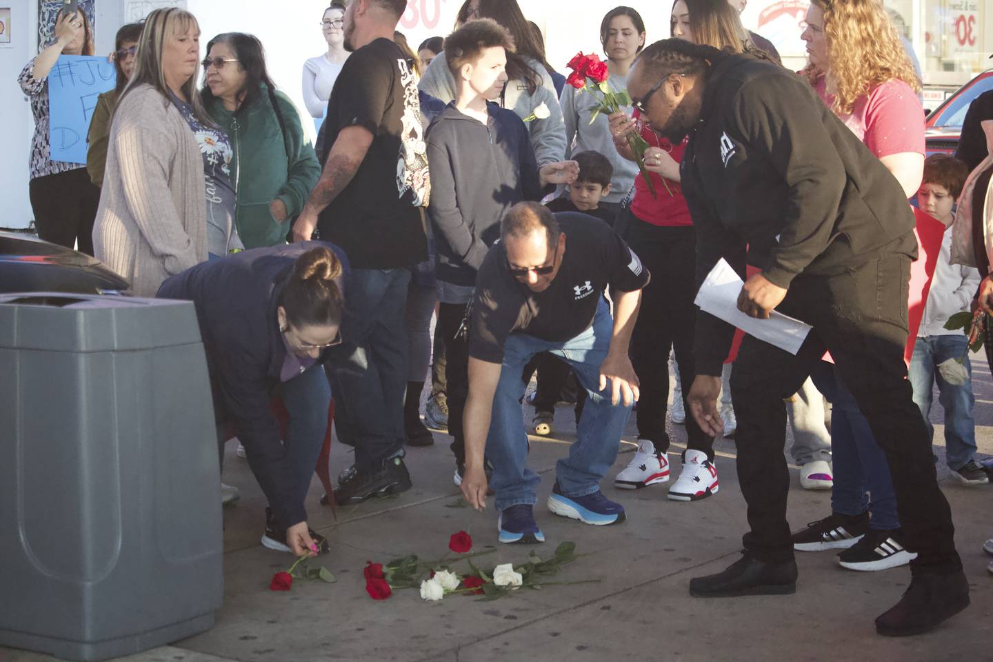 The family of David Malito, 39, and supporters lay down flowers at the spot on Monday, May 5, 2025, where he was on the ground with Joliet police officers who responded to a 911 call from Malito on Dec. 25, 2024 at Shell gas station, 401 S. Larkin Avenue, Joliet.