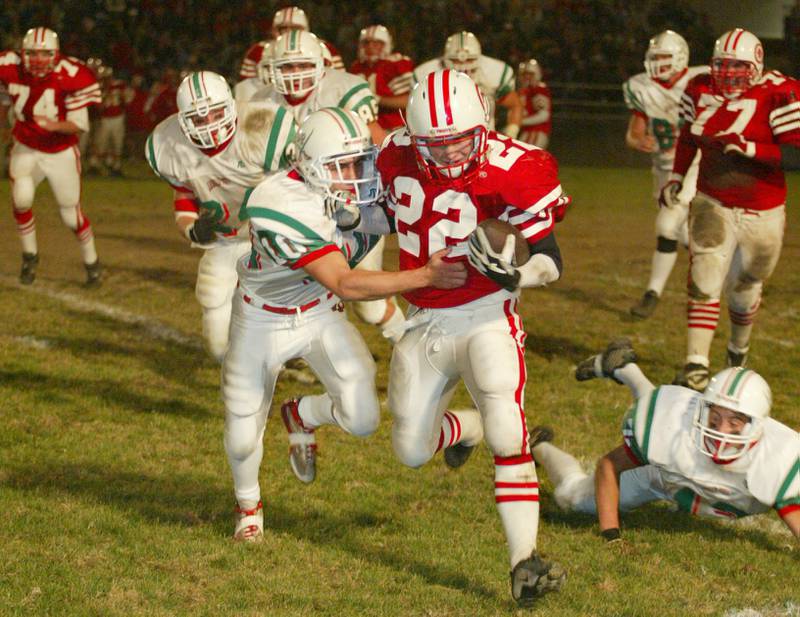 Ottawa's B.J. Armstrong (22) tries to break a tackle by La Salle-Peru's Tim Wawerski (10) during the 2002 game at King Field.