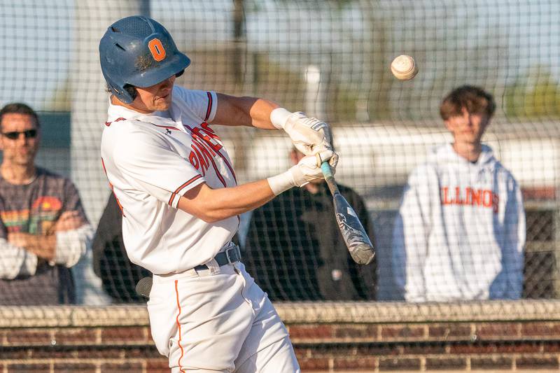 Oswego’s Trey Hernandez (14) hits a deep fly-ball against Minooka during a baseball game at Oswego High School on Tuesday, April 18, 2023.