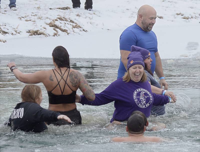 Sixteen teams of divers participated Saturday, Jan. 28, 2023, in the Penguin Plunge at Skydive Chicago. Some participants did a slight stroll into the frigid water while others dove right in. The event is a fundraiser for the Make-A-Wish foundation.