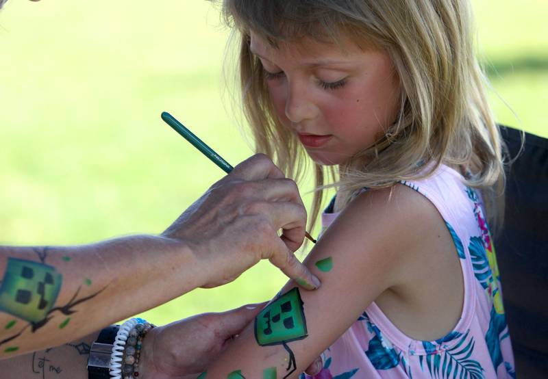 Paige Hansen, 8, of Cary has her arm painted during the Stars N’ Stripes Fest at Cary-Grove Park in Cary on Saturday, June 28, 2025.
