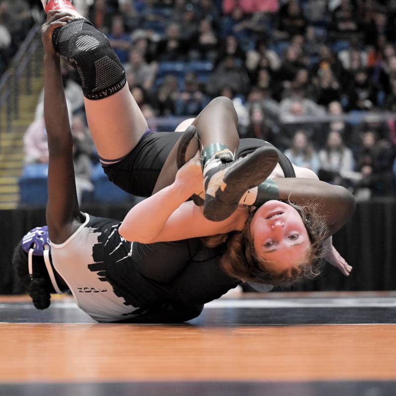 Hampshire’s Stella Piazza is thrown over backwards by Chicago Hope’s Demitria Griffin in the 115-pound class at the girls wrestling state finals tournament at Grossinger Arena in Bloomington on Saturday, Feb. 28, 2026.