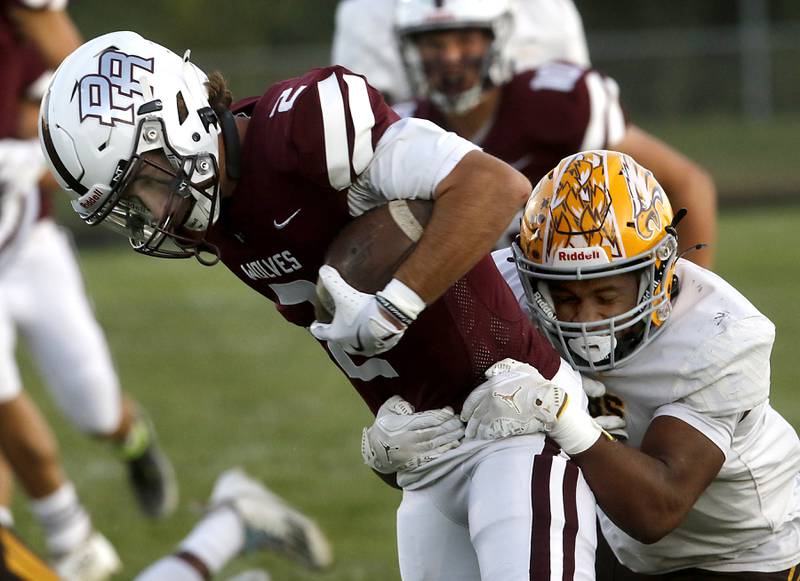 Prairie Ridge's Logan Thennes is tackled by Jacobs' Michael Cannady during a Fox Valley Conference football game on Friday, Sept. 5, 2025, at Prairie Ridge High School in Crystal Lake.