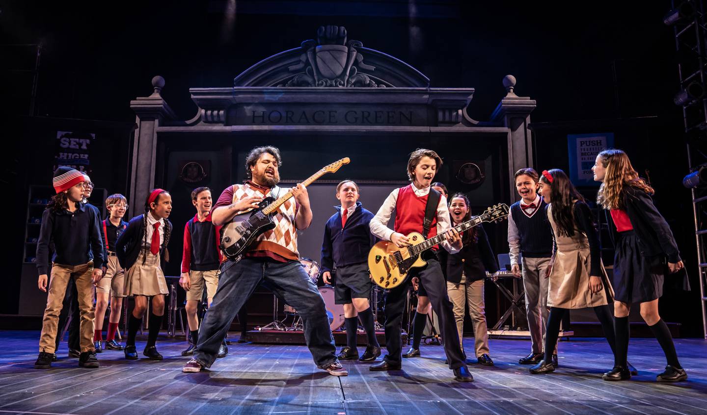 Nick Druzbanski (front, left) plays Dewey Finn and Julian Wanderer is Zack Mooneyham in Paramount Theatre’s School of Rock, based on the hit Jack Black movie, with new music from Andrew Lloyd Webber. Also pictured, back, from left: David Mattle, Gabriel Solis, Leighton Tantillo, Naya Rosalie James, Charlie Long, Elias Totleben, Julia Dale (obstructed), Omi Lichtenstein, Jaxon Mitchell, Meena Sood and Maya Keane. Trent Stork directs. Performances are April 12-June 4, 2023. For tickets and information, visit paramountaurora.com, or call (630) 896-6666. Photo credit: Liz Lauren