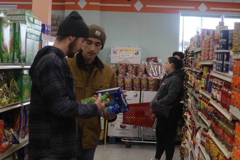 Customers peruse the aisles at DeKalb Fresh Market, 304 N. Sixth St., DeKalb, during the store's grand opening on Tuesday, Nov. 21, 2023.