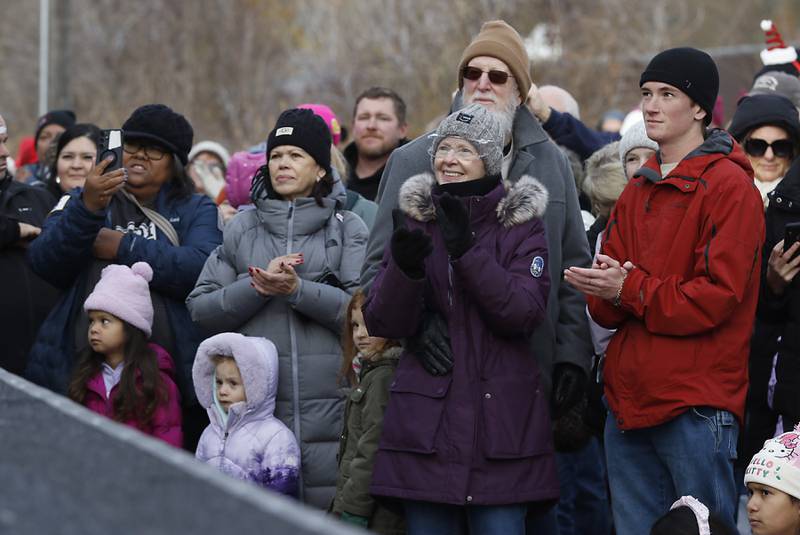 People watch as KT Tunstall sings a song during a stop in Pingree Grove on Wednesday Nov. 27, 2024, by the Canadian Pacific Kansas City Railway 2024 Holiday Train. The holiday train raised food and monetary donations for the D300 Food Pantry during its stop in Pingree Grove.