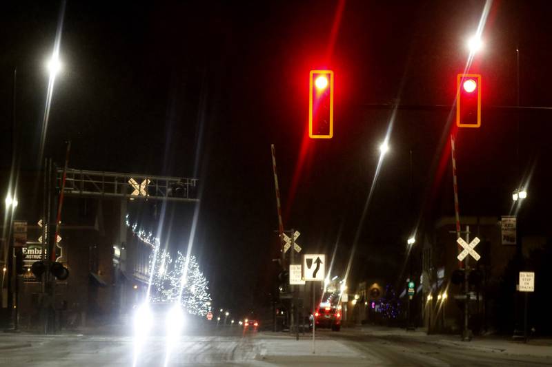 Lightly falling snow creates interesting reflections off of the traffic and street lights on Wednesday, Jan. 22, 2024, in Huntley.