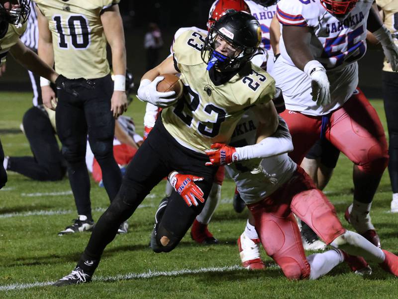 Sycamore's Dylan Hodges tries to get away from Cahokia's Malik Mazyun during their game Friday, Oct. 25, 2024, at Sycamore High School.
