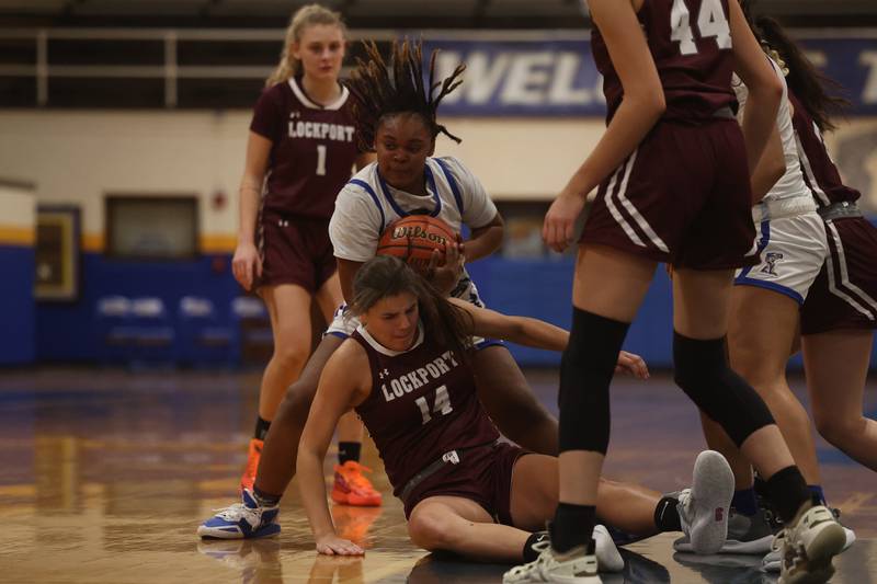 Joliet Central’s Alexi Bradley wins the loose ball battle against Lockport.