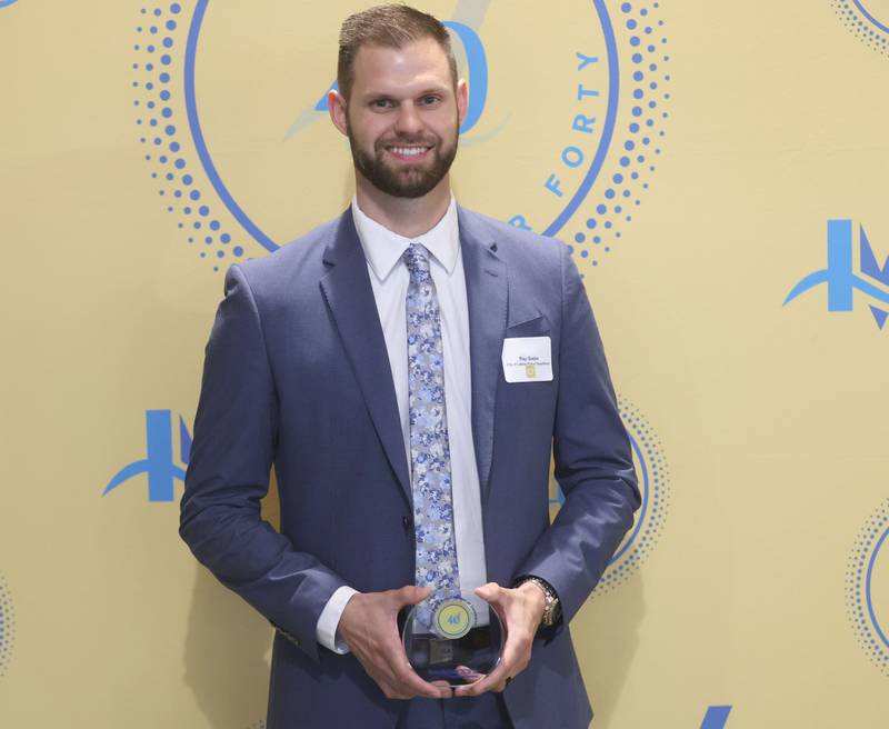 Ray Gatza poses with his 40 Under Forty award during the Illinois Valley Chamber of Commerce Champions of Change Awards Night on Wednesday, May 6, 2026 at the Westclox Event Center in Peru.