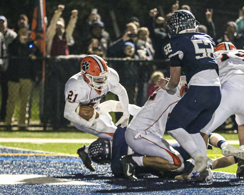 Byron's Chandler Binkley (21) dives in for a late touchdown during Class 3A semifinal game between Byron at IC Catholic Prep.  Nov 20, 2021.