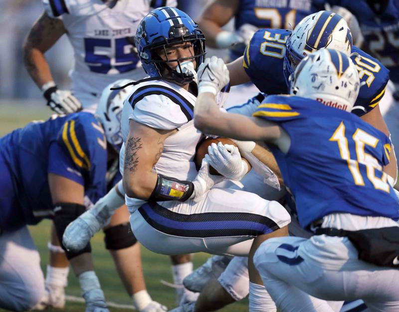 Brian Hill/bhill@dailyherald.com
Lake Zurich's Calen Grabowski (8) moves through a host of Wheaton North players during the second round of the IHSA playoffs Saturday November 5, 2022 in Wheaton.