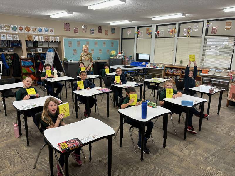 The students in St Andrew's third grade class of teacher Lisa Briniger received their own personal age-appropriate dictionary from Rock Falls Rotarian Cheryl Faber (in back of room)..