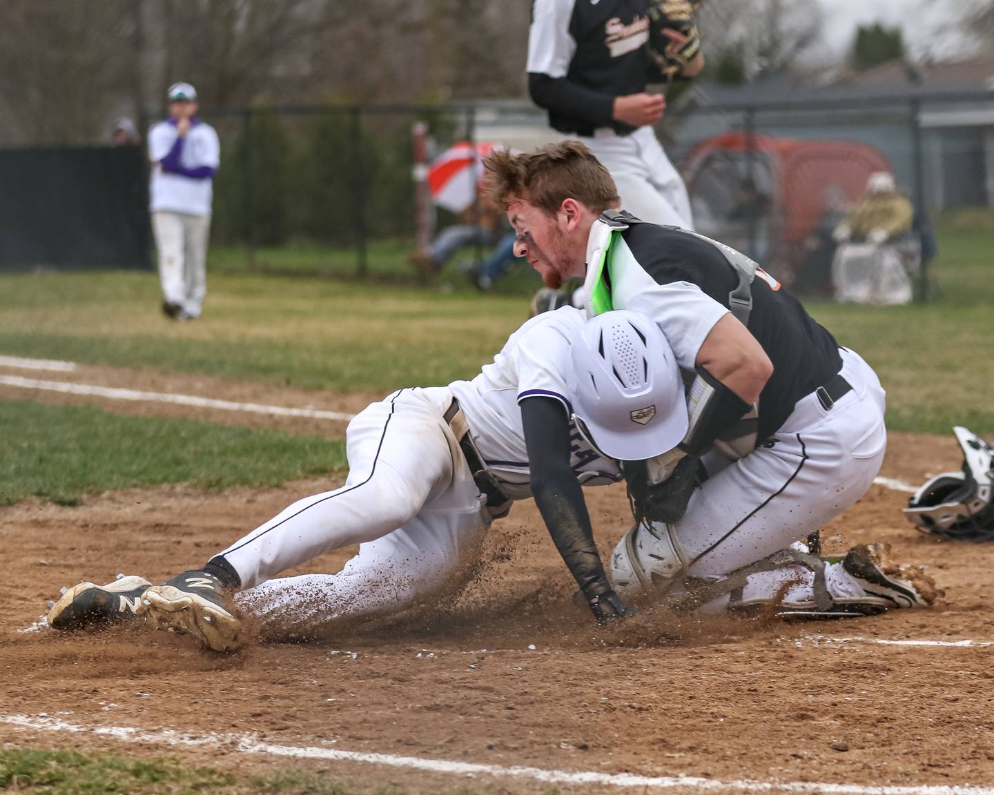 Plano's Joshua Stellwagen (5) collides at the plate with Sandwich's Jeffery Ashley (8) during baseball game between Sandwich at Plano on Thursday, April 9, 2025 in Plano.