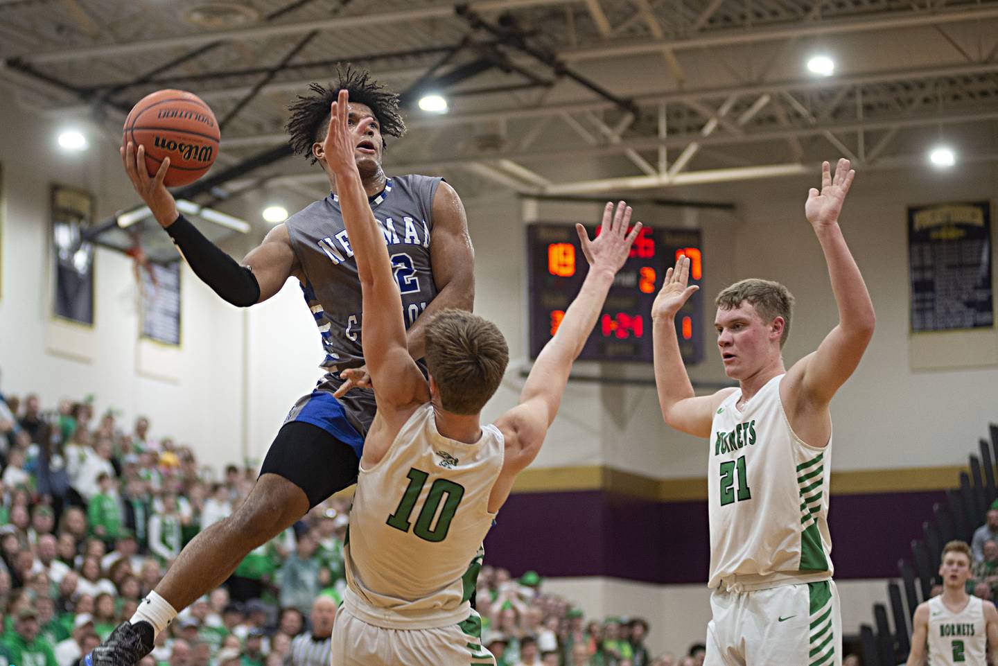 Newman's Marcus Williams is called for charging while driving to the hoop against Scales Mound in the sectional final Friday, March 4, 2022.