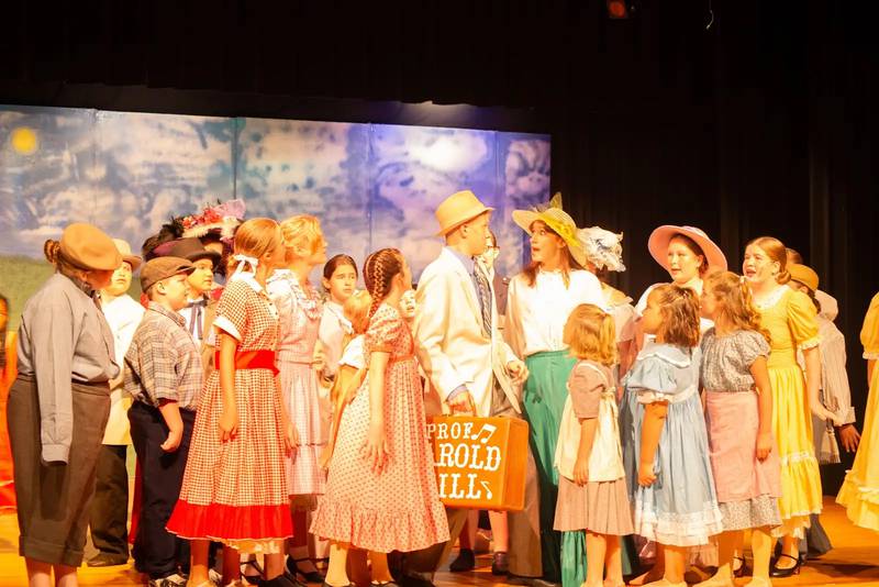 Cast members rehearse a scene from The Music Man Jr. at Engle Lane Theatre in Streator. The show opens Saturday, July 13, and runs through Thursday, July 18.