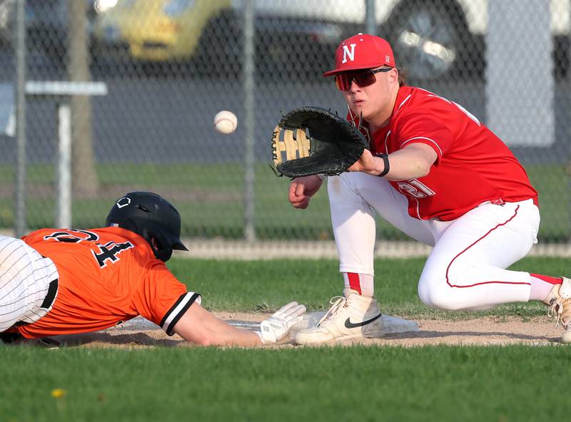 DeKalb's Evan Johnson gets back to first safely as Naperville Central's Troy Kashul takes the throw on a pickoff attempt Monday, April 28, 2025, during their game at DeKalb High School.