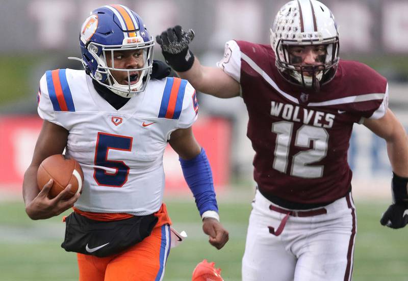 East St. Louis quarterback Tyler Macon runs for a touchdown ahead of Prairie Ridge senior George Concialdi during their Class 6A state football championship game Saturday in Huskie Stadium at Northern Illinois University.