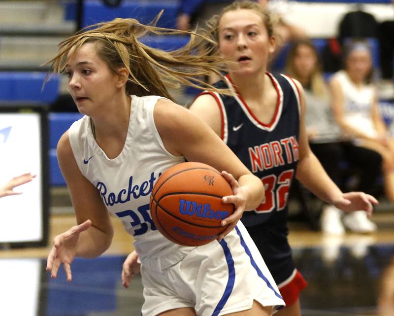 Burlington Central's Emma Payton push the ball up the court against Belvidere North's Cortlyn Hefty on Monday, Nov. 13, 2023, during pool play girls basketball game in the Burlington Central Mark Einwich Tournament.