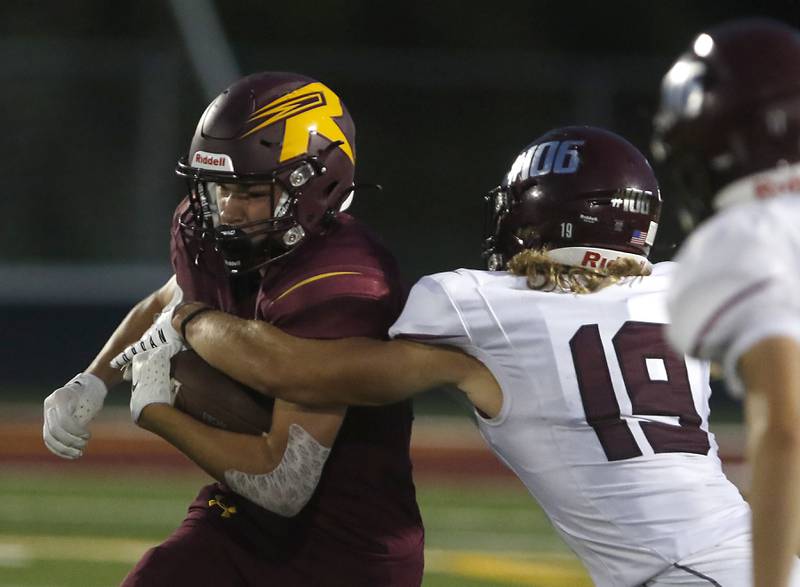 Richmond-Burton’s Jack Martens tries to run through the tackle attempt of Marengo’s Owen Frederick during a Kishwaukee River Conference football game Friday, Sept. 9, 2022, between Richmond-Burton and Marengo at Richmond-Burton Community High School.