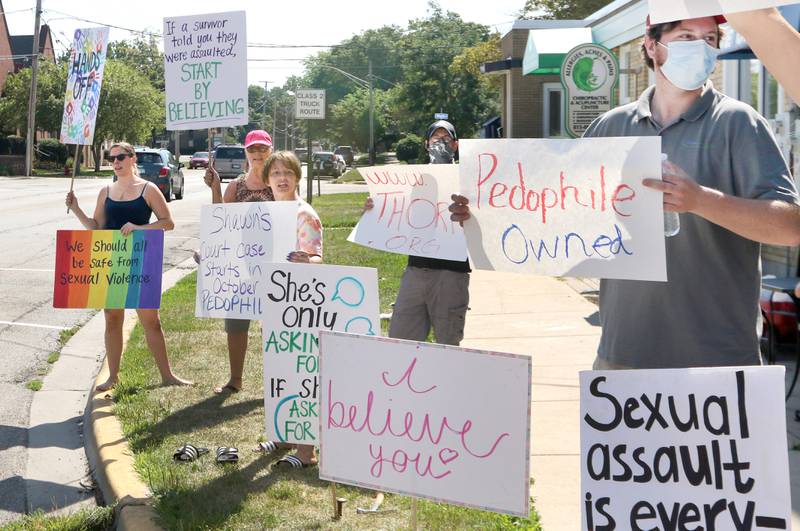 Protesters chant Friday in front of Shawn's Coffee Shop in Sycamore to inform the public of allegations that the owner, Shawn Thrower, committed misdemeanor battery against a 15-year-old employee. Thrower allegedly bit and inappropriately touched the employee.
