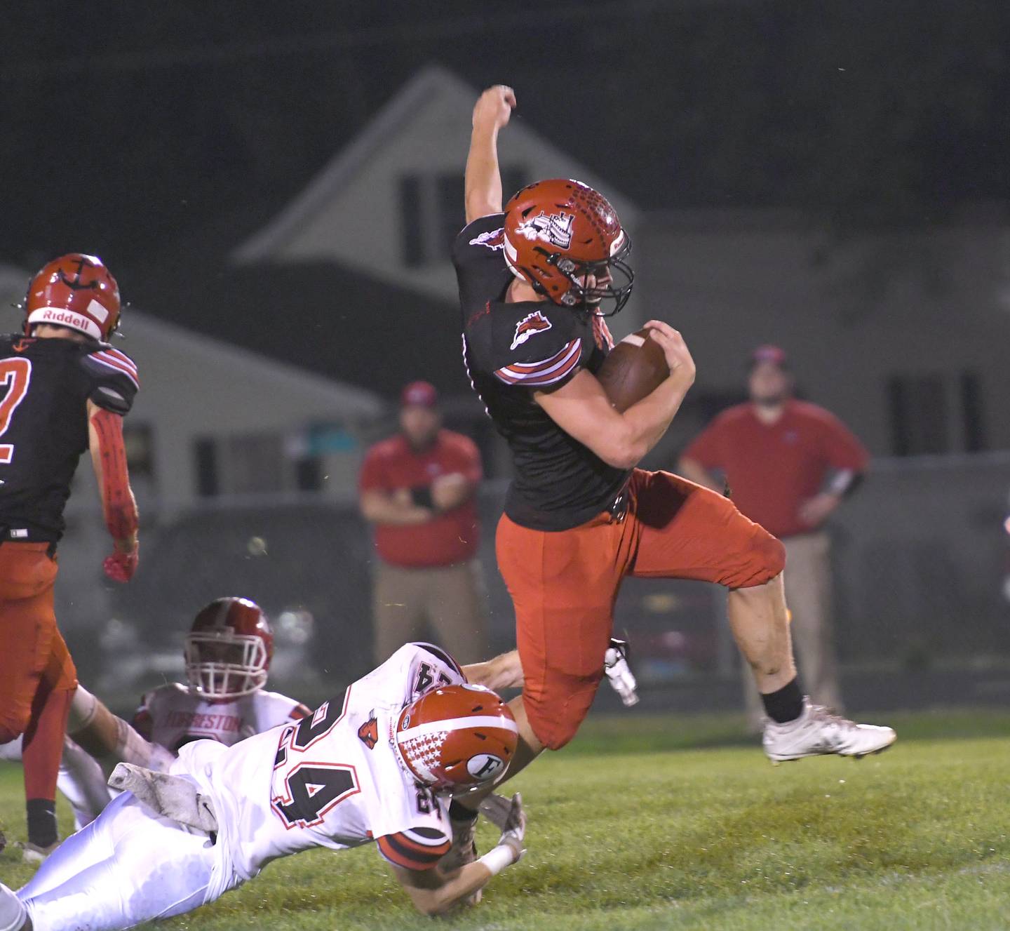 Fulton's Keegan VanKampen keeps his balance and gains a yards as Forreston's Peyton Encheff reaches for the tackle.