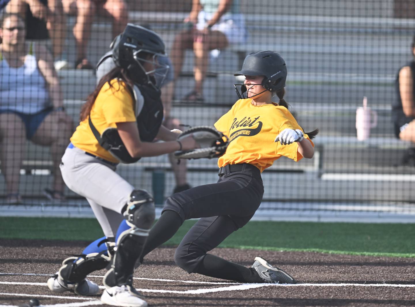 Joliet West's Macey Gorsch (22) slides to home plate to score a run during the conference game against Joliet Central on Monday, May. 12, 2025, at Joliet.