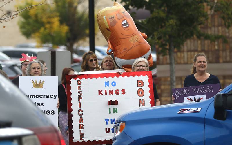 Protesters line Route 31 during a "No Kings” protest rally on Saturday, Oct. 18, 2025, in McHenry. The protest drew thousands of protesters to the area to protest the policies of President Donald Trump.