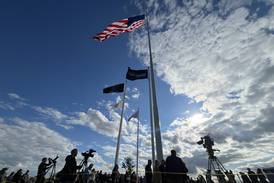 Raynor ceremoniously raises giant American flag above Dixon facility 