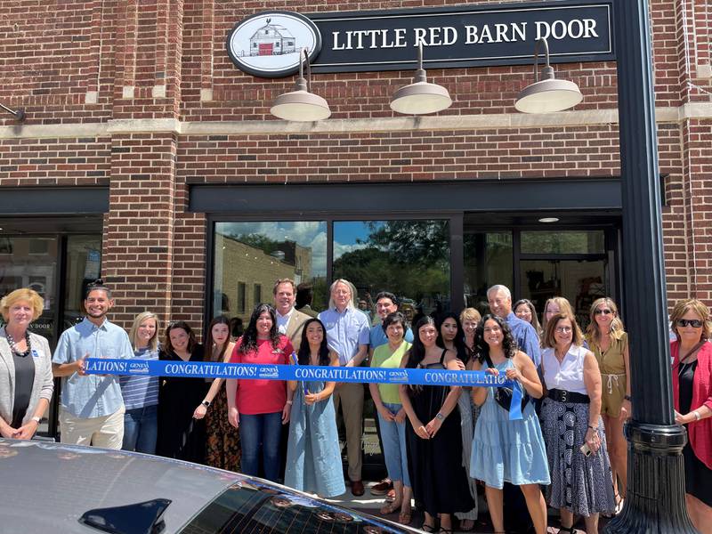 Little Red Barn Door owner Sylvia Torres (in red) along with family members at a ribbon cutting ceremony July 29, 2022