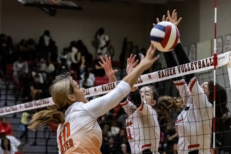 Minooka's Courtney Walter taps the ball over the net during a varsity volleyball away game against Bolingbrook on Sept. 25, 2025.