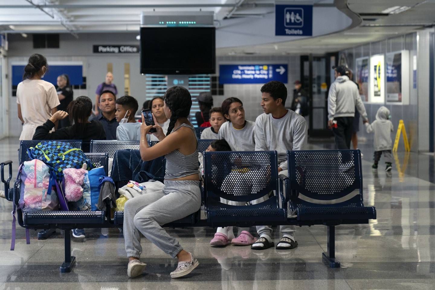 Run by a private firm hired by the city, migrants stay in a makeshift shelter at O'Hare International Airport, Wednesday, Sept. 20, 2023, in Chicago. Unlike migrants in the public eye at police stations, the migrants at O'Hare and a handful at Midway International Airport have limited access to resources, including showers and medical care. (AP Photo/Erin Hooley)