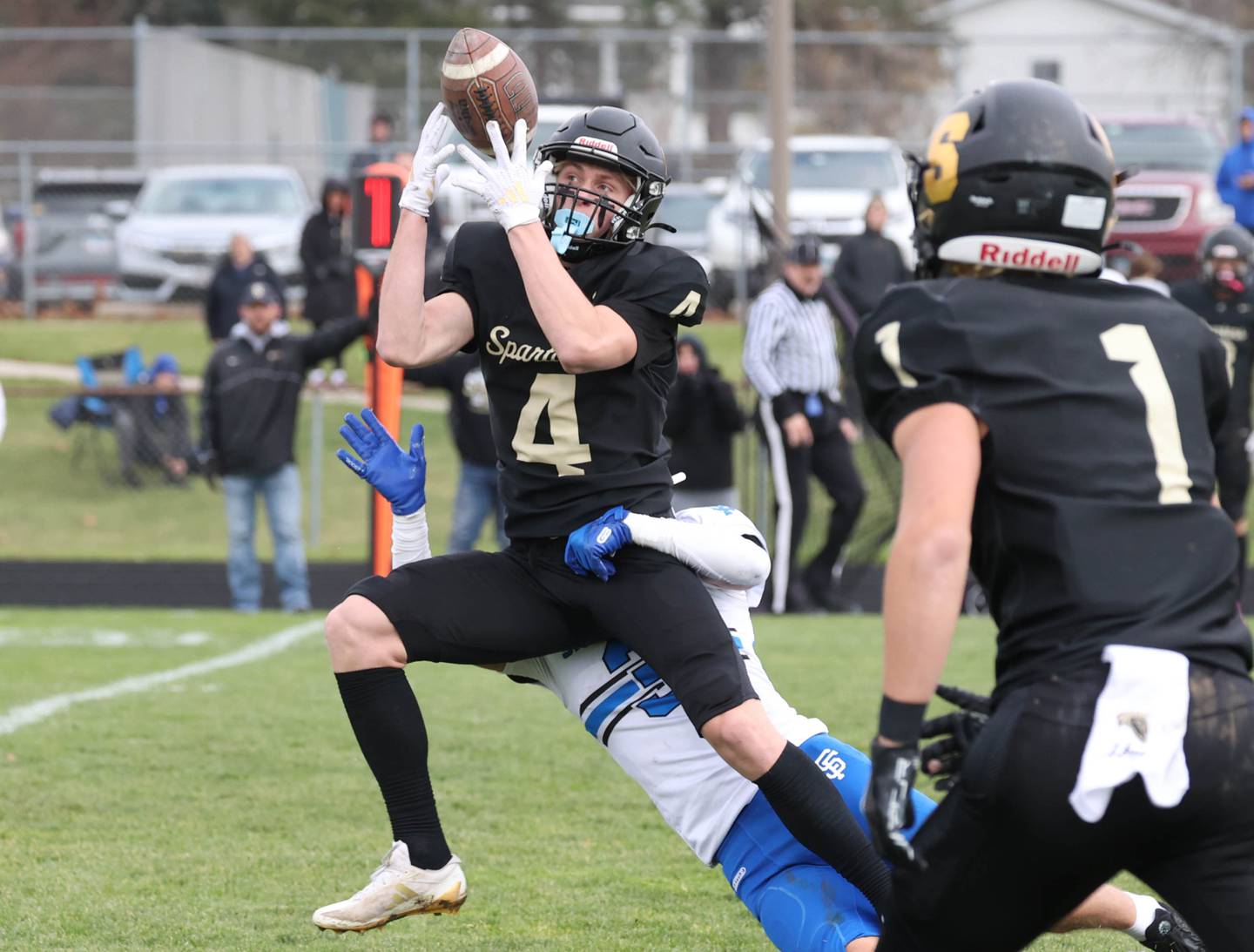 Sycamore's Aidan Wyzard tries to hold on to the ball after a hit from St. Francis' Seth Valeri Saturday, Nov. 16, 2024, during their Class 5A quarterfinal game at Sycamore High School.
