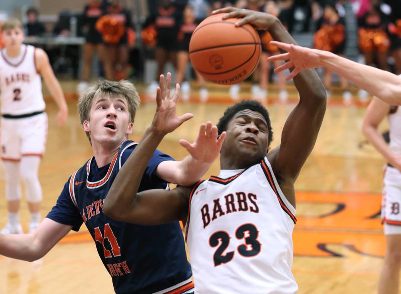 DeKalb’s Davon Grant grabs a rebound in front of Naperville North's Jack Kallstrand during their game Friday, Dec. 8, 2023, at DeKalb High School.