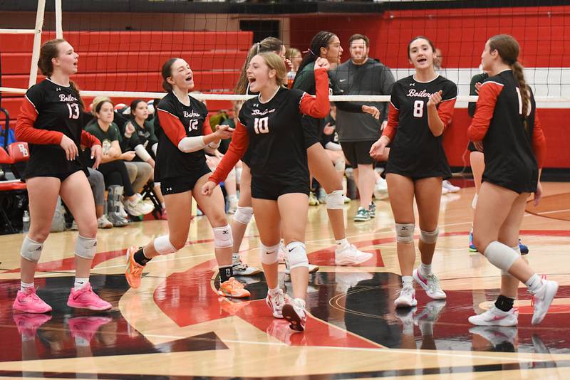 Members of the Bradley-Bourbonnais girls volleyball team celebrate a point during their 2-0 All-City home win over Bishop McNamara Wednesday, Sept. 10, 2025.