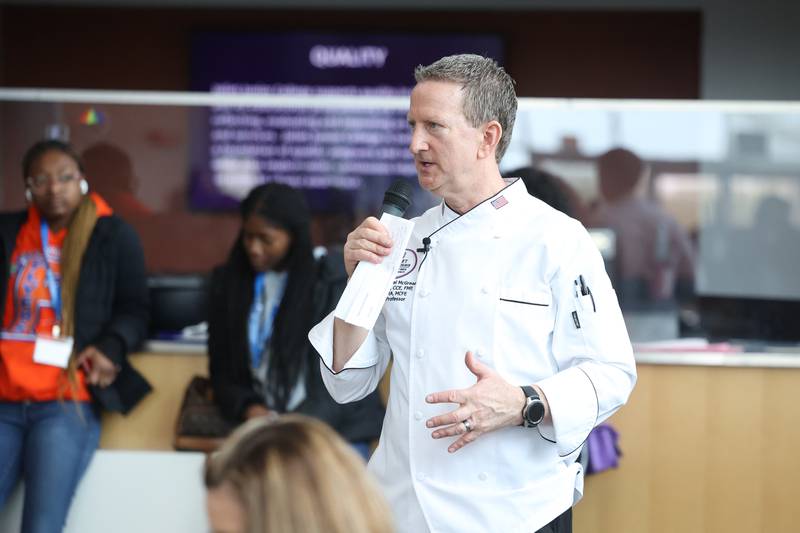 Chef Michael McGreal, Department Chair at Joliet Junior College, talks with high school students at a nutritional and wellness event hosted by Joliet Junior College on Friday, April 21, 2023 in Joliet.