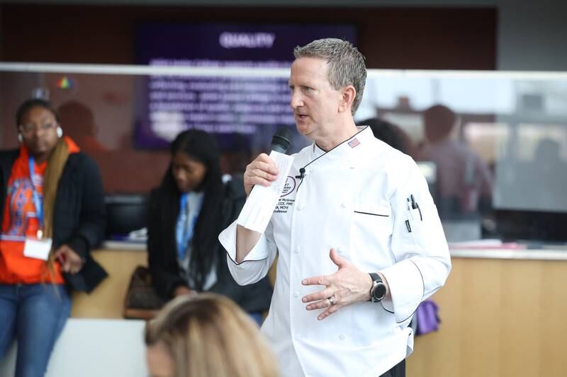 Chef Michael McGreal, Department Chair at Joliet Junior College, talks with high school students at a nutritional and wellness event hosted by Joliet Junior College on Friday, April 21, 2023 in Joliet.