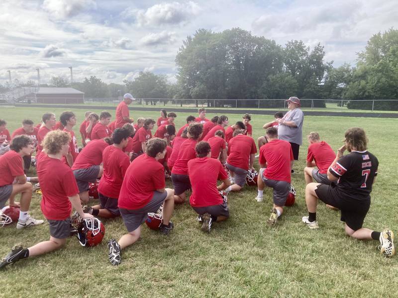 Hall coach Randy Tieman gets a break at end of the Red Devils first practice Monday morning. They will open the season Friday, Aug. 25 at Orion.