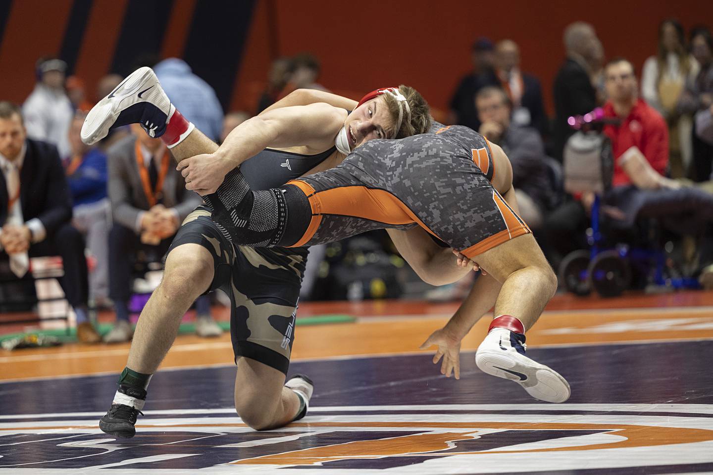 Jimmy Mastny of Woodstock Marian tosses Washington’s  Josh Hoffer in the 2A 215 pound title Saturday, Feb. 21, 2026, at the IHSA wrestling finals in Champaign.