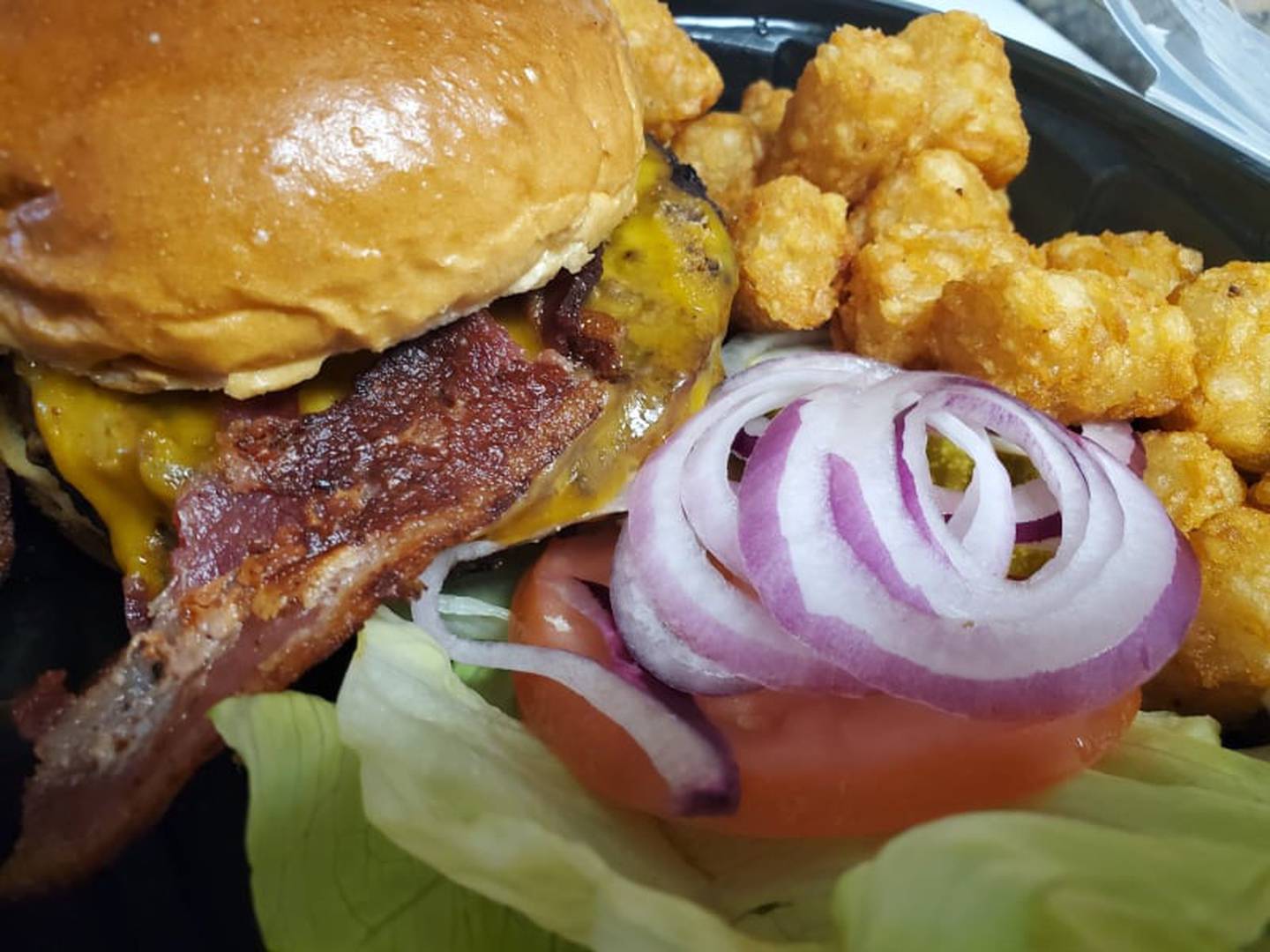 Jameson's Pub in Joliet has a bacon cheddar burger for $19 and a side of tater tots for $2. This burger arrived with a nice “char” on the outside and cooked medium as ordered.