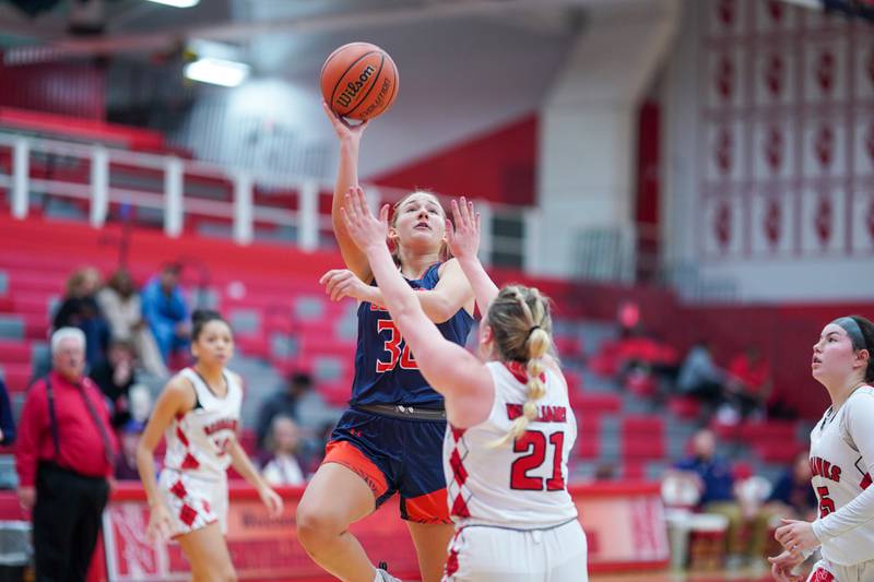 Oswego’s Peyton Johnson (30) shoots the ball in the paint against Naperville Central during a basketball game at Naperville Central High School on Friday, Nov 17, 2023.