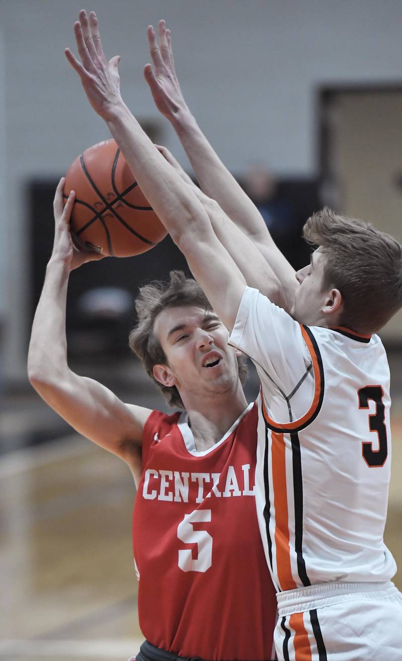 Naperville Central’s Jonathan Boomgarden tries to get a clear shot against St. Charles East’s Jack Borri in a boys basketball game in St. Charles on Wednesday, January 25, 2023.