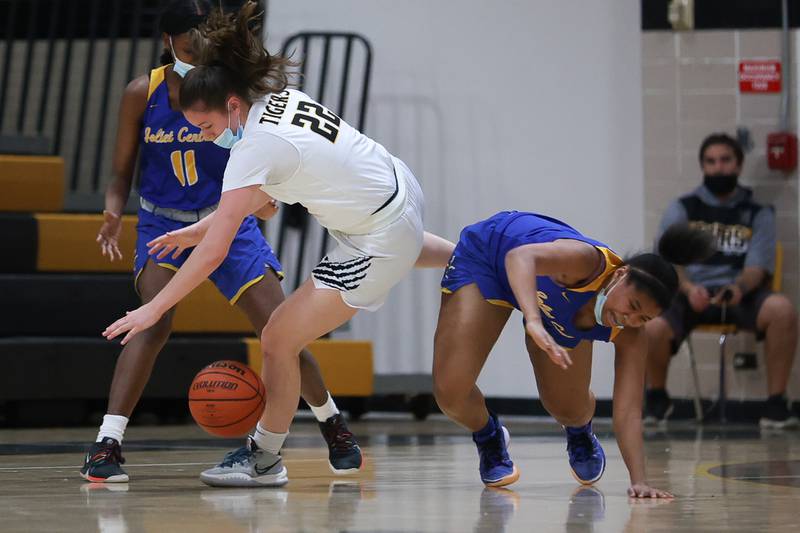 Joliet West’s Grace Walsh collides with Joliet Central’s Kiyah Davis going for the ball in the Class 4A Moline Regional semifinal. Tuesday, Feb. 15, 2022, in Joliet.