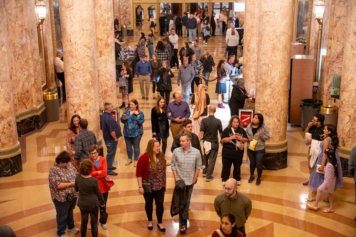 Concert attendees for the Vitamin String Quartet enter the lobby for the reopening of the Rialto Square Theatre in Joliet, Ill. on Tuesday Oct. 22, 2024
