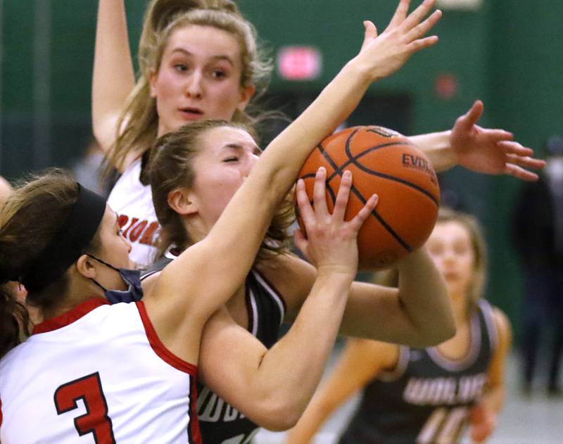 Prairie Ridge's Karsen Karlblom tries to shoot through the double team of Deerfield's Olivia Kerndt, background, and Aubrey Gavan, foreground, during a IHSA Class 3A Grayslake Central Sectional semifinal basketball game Tuesday evening, Feb. 22, 2022, between Prairie Ridge and Deerfield at Grayslake Central High School.